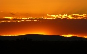 Fiery Sunset Behind the Mountains