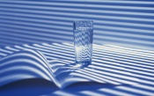 Glass Of Water And A Book On The Table