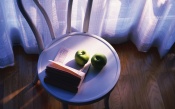 Apples And A Book On A Chair By The Window