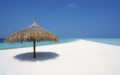 Maldives, Beach Umbrella And Placid White Beach maldives