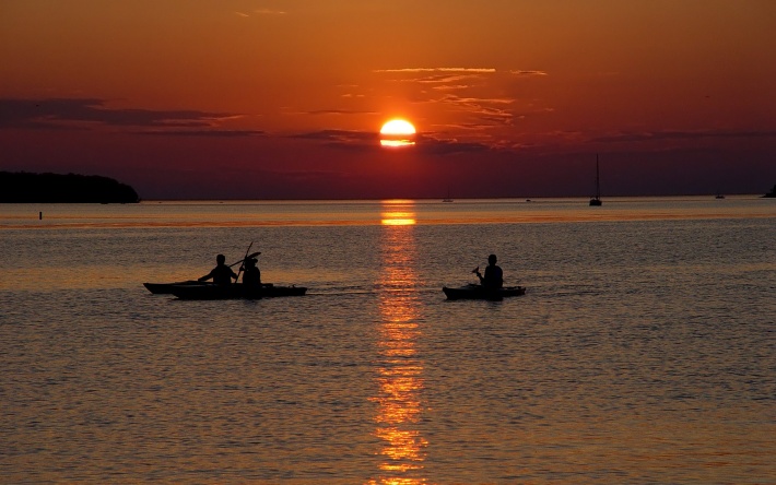 Boat Floating on the Water at Sunset