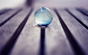 Glass Ball on a Wooden Floor