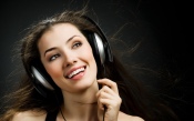 The Girl in Headphones on a Black Background