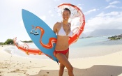 Girl With Kite and Surfboard on the Beach